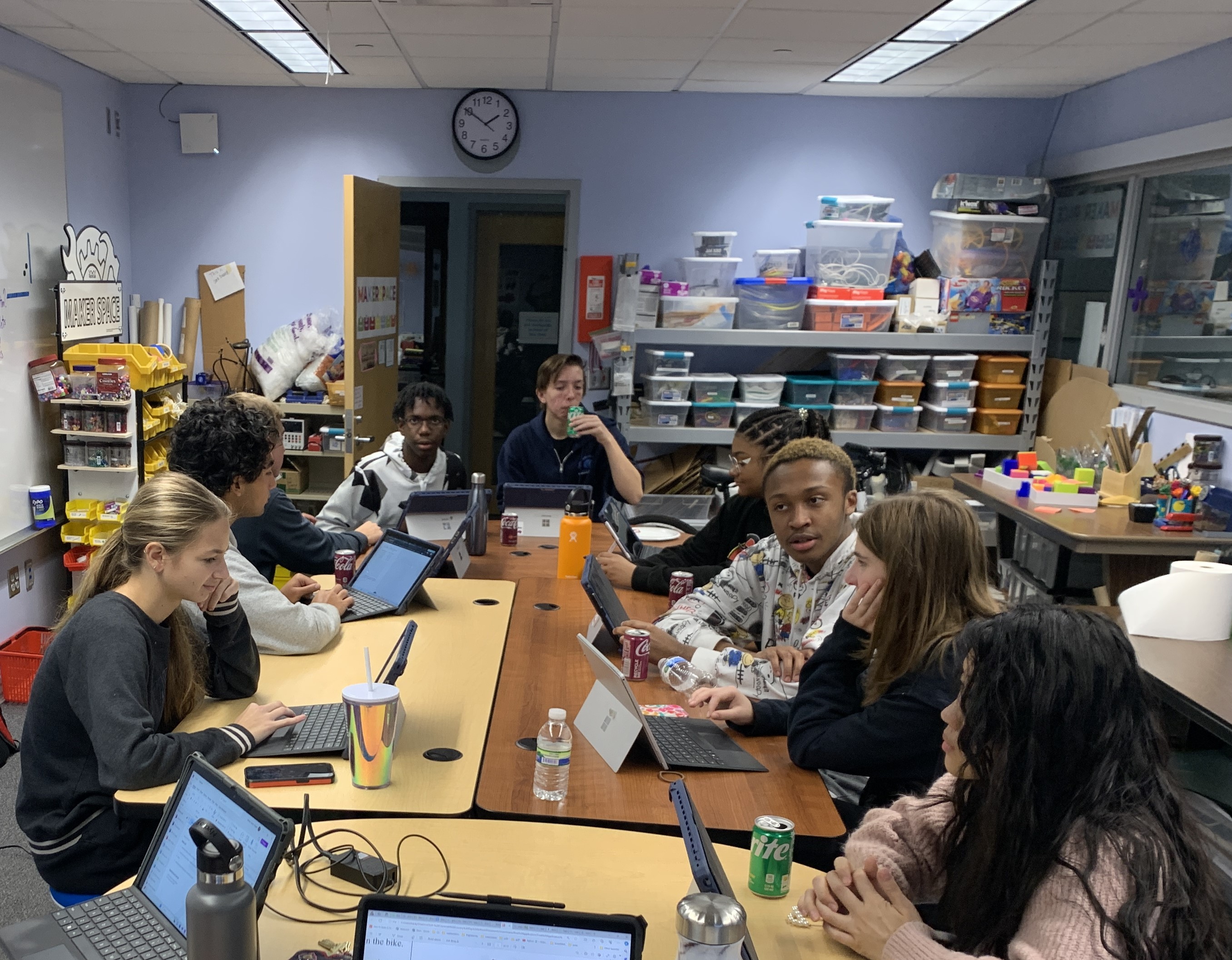 InvenTeam sits around the table in the makerspace