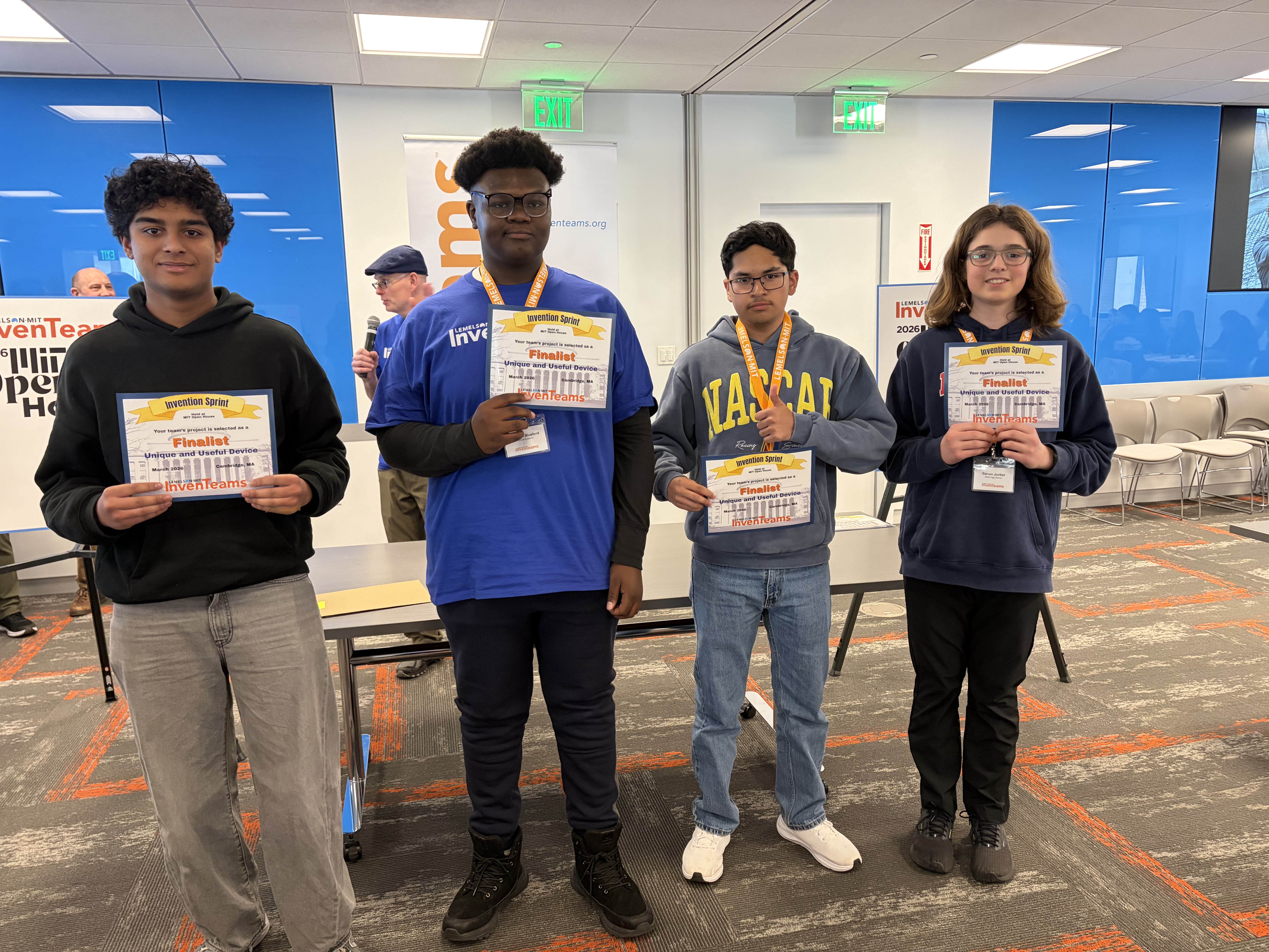 Four students show their finalists certificates