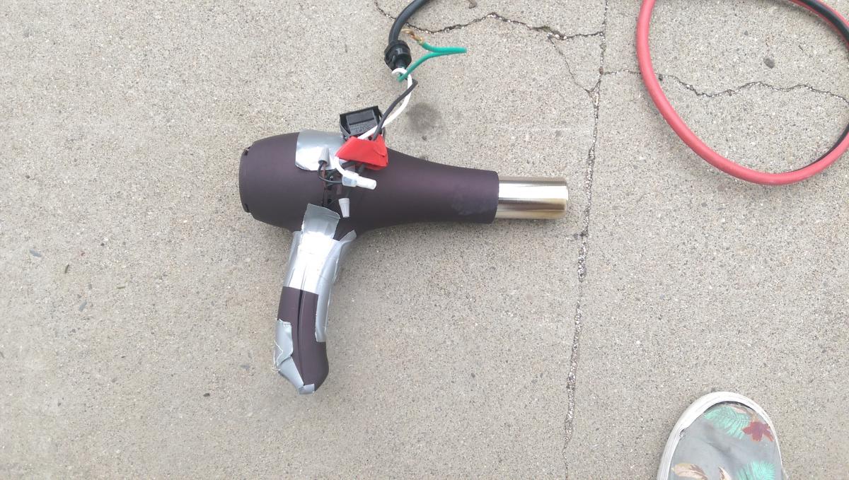 [Hair dryer shell with heater unit inside.]
