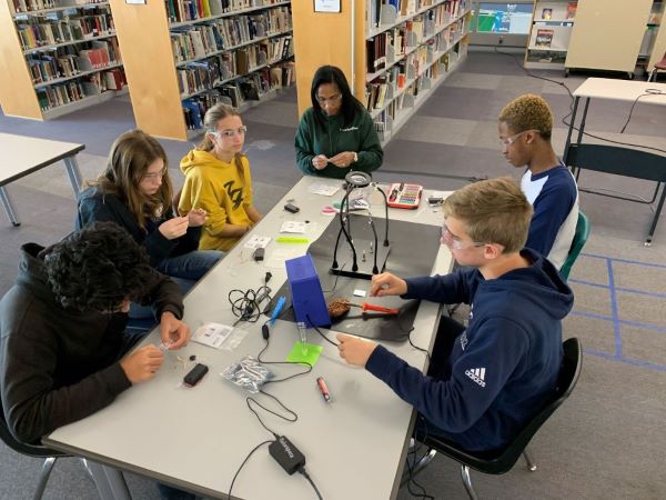 Team works on soldering