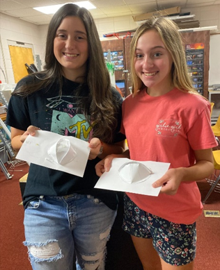 breland and kameryn showing the paper prototype