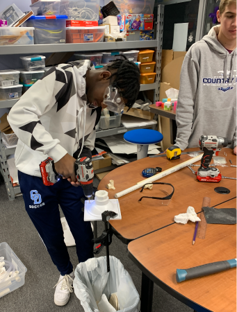 Tech Team Member Donovan Gray works on testing device