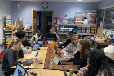 InvenTeam sits around the table in the makerspace